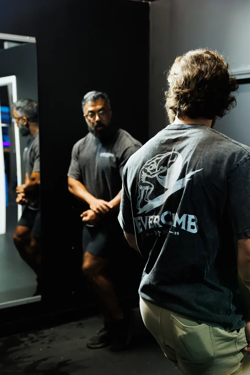 An EverClimb coach speaking with an athlete during a gym session