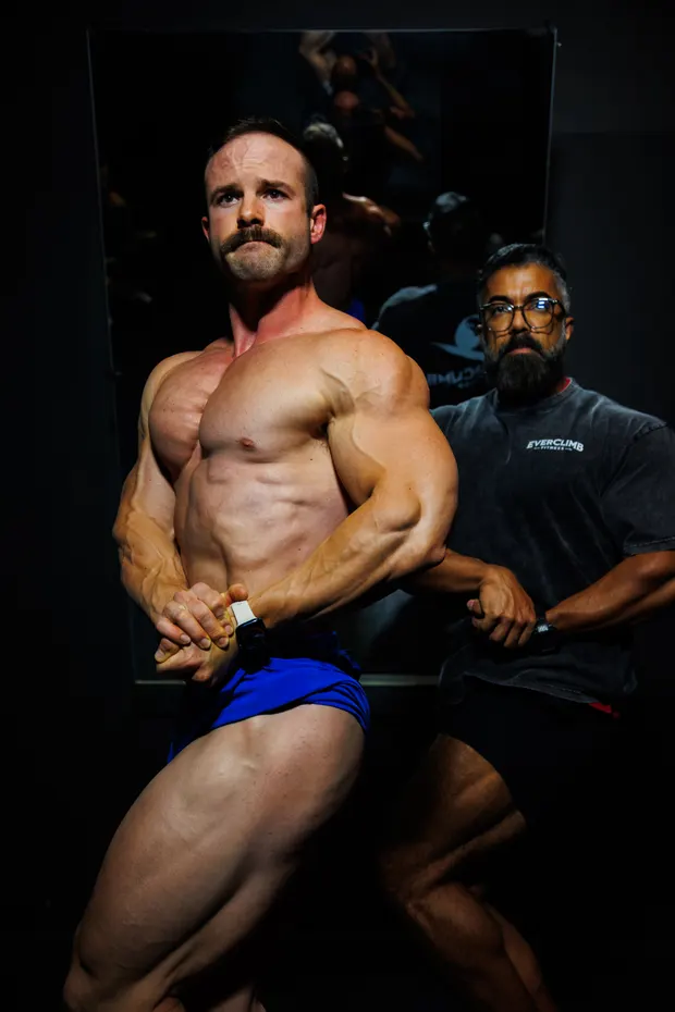 EverClimb coach guiding a bodybuilding athlete through posing practice